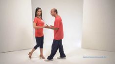 a man and woman walking in an empty room