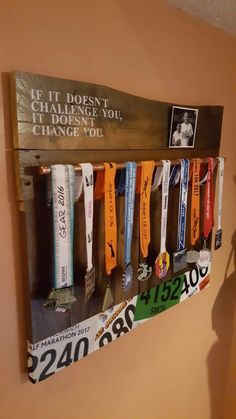 a wall mounted medal rack with medals hanging from it's sides and the words if it doesn't change you, change you chance to change you