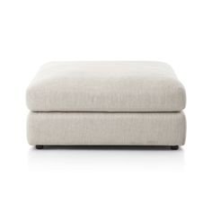 the footstool is shown in white linen