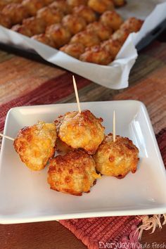 small appetizers are sitting on a plate with toothpicks stuck in them