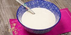 a blue and white bowl filled with oatmeal on top of a pink napkin