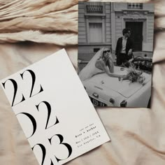 two black and white photos on a bed next to each other with the same wedding date printed on them