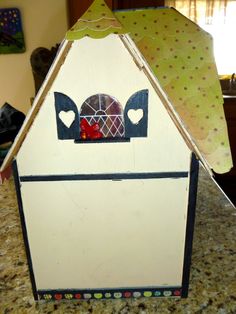 a house made out of cardboard sitting on top of a counter