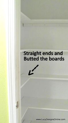 an empty closet with white shelving and black arrows pointing to the bottom right hand corner