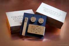 two wooden cufflinks are sitting on a table