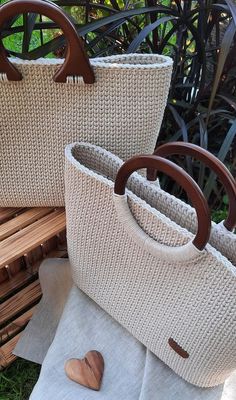 two woven bags sitting on top of a wooden bench