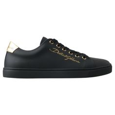 Step Into Luxury With These Stunning, Brand New Classic Sneakers From The Iconic Fashion House Dolce & Gabbana. Crafted From Premium 100% Leather In A Sleek Black With Gold Accents, These Shoes Are Not Just A Statement Of Style, But A Testament To Italian Craftsmanship. The Durable Rubber Sole Ensures Comfort And Longevity, While The Distinctive Logo Detail Adds An Exclusive Touch To Your Every Step. Elegance Meets Street Style With These Luxurious Sneakers, Made In Italy. Material: 100% Leather Elegant Low-top Leather Sole Sneakers, Elegant Low-top Sneakers With Leather Sole, Luxury Leather Sneakers With Metallic Logo, Luxury Calf Leather Sneakers With Logo Plaque, Chic Sneakers With Leather Sole, Luxury Calf Leather Sneakers For Formal Occasions, Elegant Black Calf Leather Sneakers, Elegant Black Round Toe Sneakers, Designer Black Sneakers With Logo Plaque