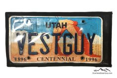 a license plate with the name utah west guy written in black and blue on it