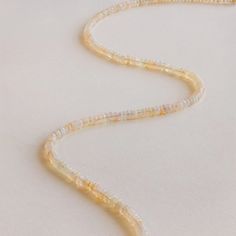 Illuminate your summer look with our Opal Beaded Necklace, featuring opals that capture and reflect light with a mesmerizing iridescence. Each bead shimmers with a radiant glow, adding a touch of bohemian charm and beauty to your sunny day style. SKU: RR-NR221 Product Details Material: High Quality Solid 925 Sterling Silver Finish: 18K Gold Featuring a ~4mm Natural Opal Beaded Necklace on an adjustable 16 to 18 inch chain Featured Styles Part of our Opal Collection Model showcases the perfect la Ethiopian Opal Beaded Necklace For Gift, Ethiopian Opal Beaded Necklace As A Gift, Bohemian Moonstone Beaded Necklaces, White Opal Bead Necklaces, White Opal Round Bead Necklaces, White Opal Round Beads Necklace, Bohemian Opal Beaded Jewelry, Opal Beaded Necklace With Gemstone Beads, Opal Beaded Necklaces With Round Beads