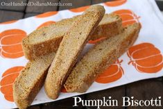 three slices of pumpkin biscotti sitting on top of a white and orange napkin