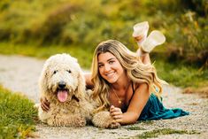 a woman laying on the ground with her dog