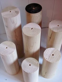 several wooden cylinders are lined up on the floor