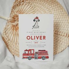 a birthday card with an image of a dog and firetruck on it next to a wicker basket