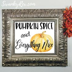 a pumpkin spice and everything nice sign in a silver frame with flowers on the wall