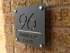 a sign on the side of a brick building that says fairwood close with black lettering