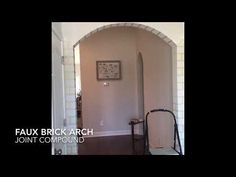 a hallway with a clock on the wall next to a stair case and an open door