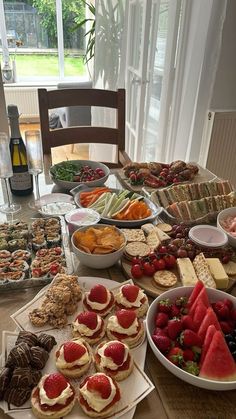 a table filled with lots of food and desserts