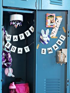 a blue locker with happy birthday signs hanging from it's sides and decorations on the door