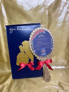 a blue book with a red ribbon around it and a gold silhouette on the cover