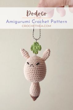 a small crocheted animal hanging from a chain with the words amigurmi crochet pattern on it