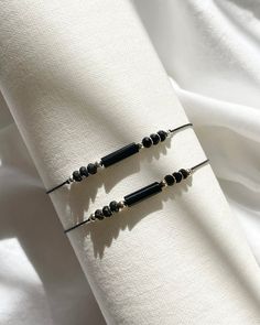 Experience the perfect blend of style and elegance with our Women's Contemporary Adjustable Silk Cord Natural Crystal Bracelet. This exquisite piece features stunning Shungite & Onyx, expertly combined with your choice of either 18K gold-filled or 925 sterling silver accents. 925 Sterling silver and 18k gold-filled components deliver lasting quality and durability. Gold-filled is made by bonding gold to a base metal, resembling solid gold without the high cost and resist tarnish and wear, ensuring your jewellery stays beautiful for years. The soft, comfortable silk cord is easily adjustable to fit any wrist size, ensuring a secure and personalized fit. African Turquoise is known for its transformative and grounding properties, while Moonstone is celebrated for its feminine energy and intui Elegant Black Bracelets For Everyday, Modern Onyx Bracelets As Gift, Modern Onyx Bracelets For Gift, Modern Onyx Bracelets For Gifts, Modern Black Beads Bracelet As Gift, Modern Black Beads Bracelets As Gift, Modern Black Beaded Bracelets As Gift, Minimalist Black Beads Bracelet As Gift, Modern Black Beaded Bracelet For Gift