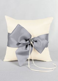 a white pillow with a silver bow on it