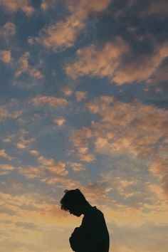 the silhouette of a man standing in front of a cloudy sky with an instagram caption below