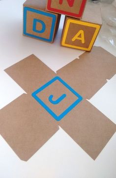 blocks spelling out the word dad on a table