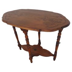 an old wooden table with carvings on the top and bottom, sitting against a white background