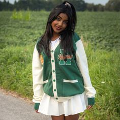 Show your Hawkins High School Pride by getting into uniform with our cozy knit cardigan featuring embroidered chenille patches. Go Tigers! 100% Acrylic Oversized Unisex Fit Embroidered Chenille Patches Stranger Things x Cakeworthy Licensed Product. Model Sizes: Male Model: Medium Female Model: Small