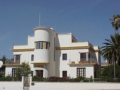 a large white building with balconies and windows