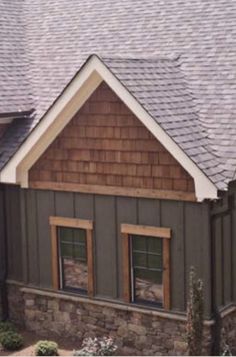 the roof of a house with two windows and a shingled dormer on it