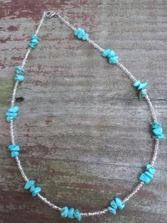 This necklace features turquoise stones and clear seed beads. Cheap Turquoise Beaded Chain Necklace, Small Beaded Necklace, White Bead Necklace, White Beaded Necklaces, Cowgirl Jewelry, Turquoise Bead Necklaces, Bead Ideas, Turquoise Stones, Chip Beads