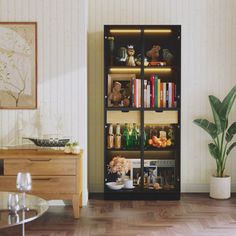 a living room filled with furniture and a tall book shelf next to a table covered in books