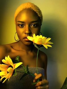 a woman holding yellow flowers in her right hand and looking at the camera with an intense look on her face