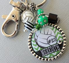 a key chain with a bottle opener attached to it and a basketball ball on top