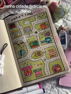 an open book with a map on top of it next to toys and other items