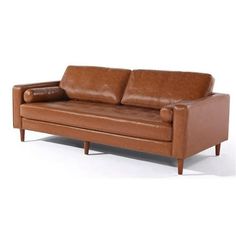 a brown leather couch sitting on top of a white floor