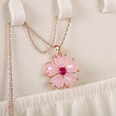 Elevate your style with our Pink Sakura Pendant Necklace, a delicate and charming accessory inspired by the beauty of cherry blossoms. Key Features: Sakura Blossom Design: The pendant showcases a beautifully detailed cherry blossom design, a symbol of ephemeral beauty and renewal. Subtle Pink Hue: The soft pink color of the pendant adds a touch of elegance and femininity to any outfit. Quality Craftsmanship: Crafted with care and precision, this necklace is made to last and retain its stunning a Feminine Blossom Flower Jewelry, Pink Flower Shaped Necklace For Weddings, Pink Flower Clavicle Chain Necklace, Spring Flower-shaped Rose Gold Necklaces, Pink Flower Necklace With Clavicle Chain, Rose Gold Flower Necklace For Spring, Spring Rose Gold Flower Necklace, Blossom Petal Shaped Jewelry For Gifts, Elegant Pink Flower Necklace For Jewelry Making