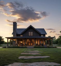 a house that is sitting in the grass with a stone walkway leading up to it