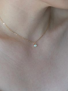 "Details: - 18K Gold Filled Cable chain - Pendant size: Approx. 6mm x 4.5mm (exclude ring) - Pendant material: Stimulated lab opal - Model wears in 15\" L necklace - This listing is only for ONE opal necklace You can clink the link below for Opal starburst necklace: https://www.etsy.com/listing/784726842/opal-necklace-star-opal-gold-opal?ref=shop_home_active_7&pro=1&frs=1 Each item is individually placed on our MIKUKUMI leather card & cotton pouch. What is Gold Filled? Gold filled is White Oval Jewelry With Delicate Chain, Dainty Gemstone Chain Necklace Gift, Tiny Gold Plated Gold Necklaces, Tiny Gold Plated Jewelry For Wedding, White Oval Gold Plated Necklace, White Oval Gold-plated Necklace, Tiny Gold Pendant Necklace, Tiny Gold Round Pendant Necklace, Gold Tiny Round Pendant Necklace