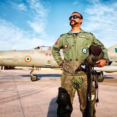 a man standing in front of a fighter jet