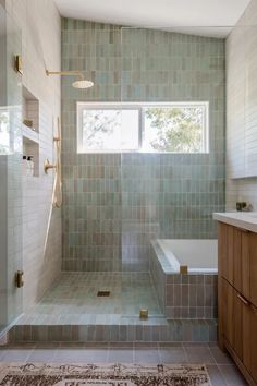 a bath room with a tub a sink and a window