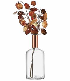 a glass vase with dried flowers in it