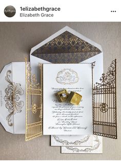 wedding stationery with gold and white accents including an envelope, ring and matching napkins