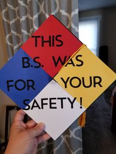 this is an image of someones hand holding up four different colored signs that say, b s was for your safety