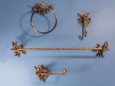 three antique brass wall mounted objects on a blue background, with one holding a ring and the other hanging from it's side