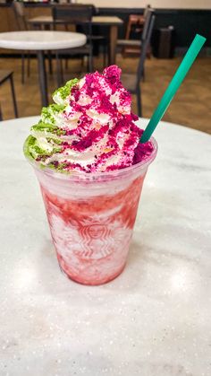 a pink and green drink sitting on top of a table