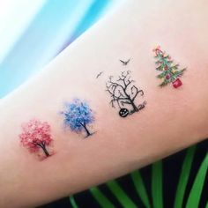 tattoos on the arm of a woman with trees and birds