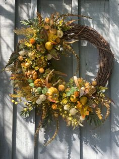 Welcome family, and friends, with this Beautiful Lush and Elegant Autumn/Thanksgiving wreath. The rich and elegant appearance of this wreath makes it a perfect statement piece for your front door, or as a indoor décor piece. This wreath is a unique subtle color mixture of  greens, golds, tan, yellow, orange, and white featuring pumpkins, pears, and thistles, surrounded by Eucalyptus, Amaranth tails, Berry Clusters, tealeaf bush, and assorted greenery.  This Grapevine Wreath has finished dimensio Eucalyptus And Orange Wreath, Vase Ideas, Fall Decor Wreaths, Fall Thanksgiving Wreaths, Wreath Pumpkin, Gift Wreath, Neutral Fall Decor, Cozy Fall Decor, Thanksgiving Wreath